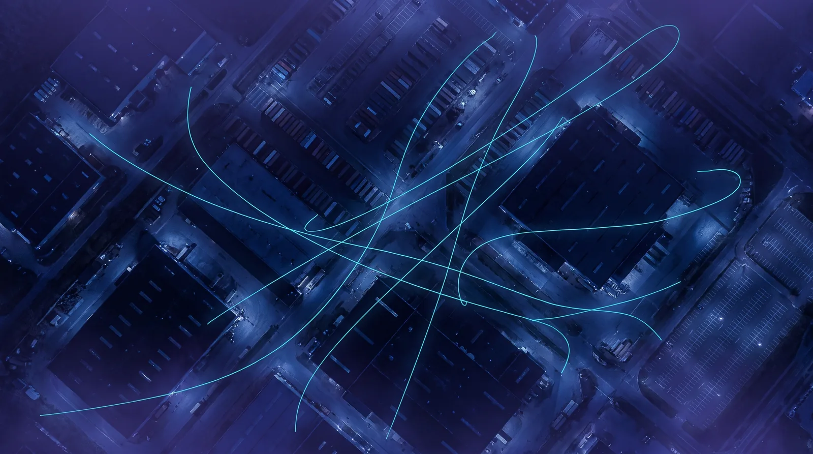 Overhead night view of a large industrial complex crossed by several glowing flight paths, each on a different, irregular route.